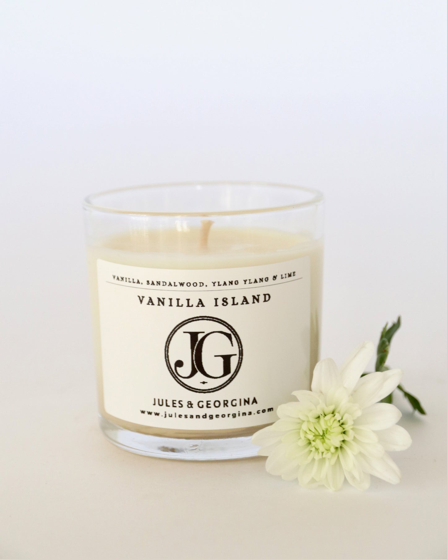 Candle with 'Vanilla Island' label and 'Jules & Georgina' branding on a white background