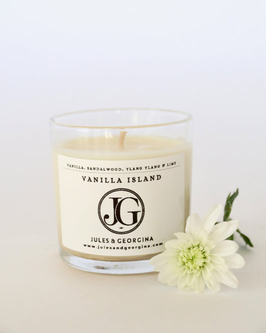 Candle with 'Vanilla Island' label and 'Jules & Georgina' branding on a white background